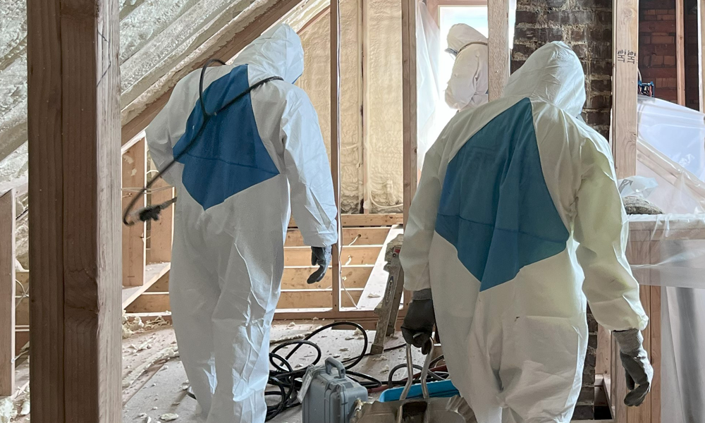 Skilled Workers in Protective Safety Gear Ensuring Safe Insulation Installation